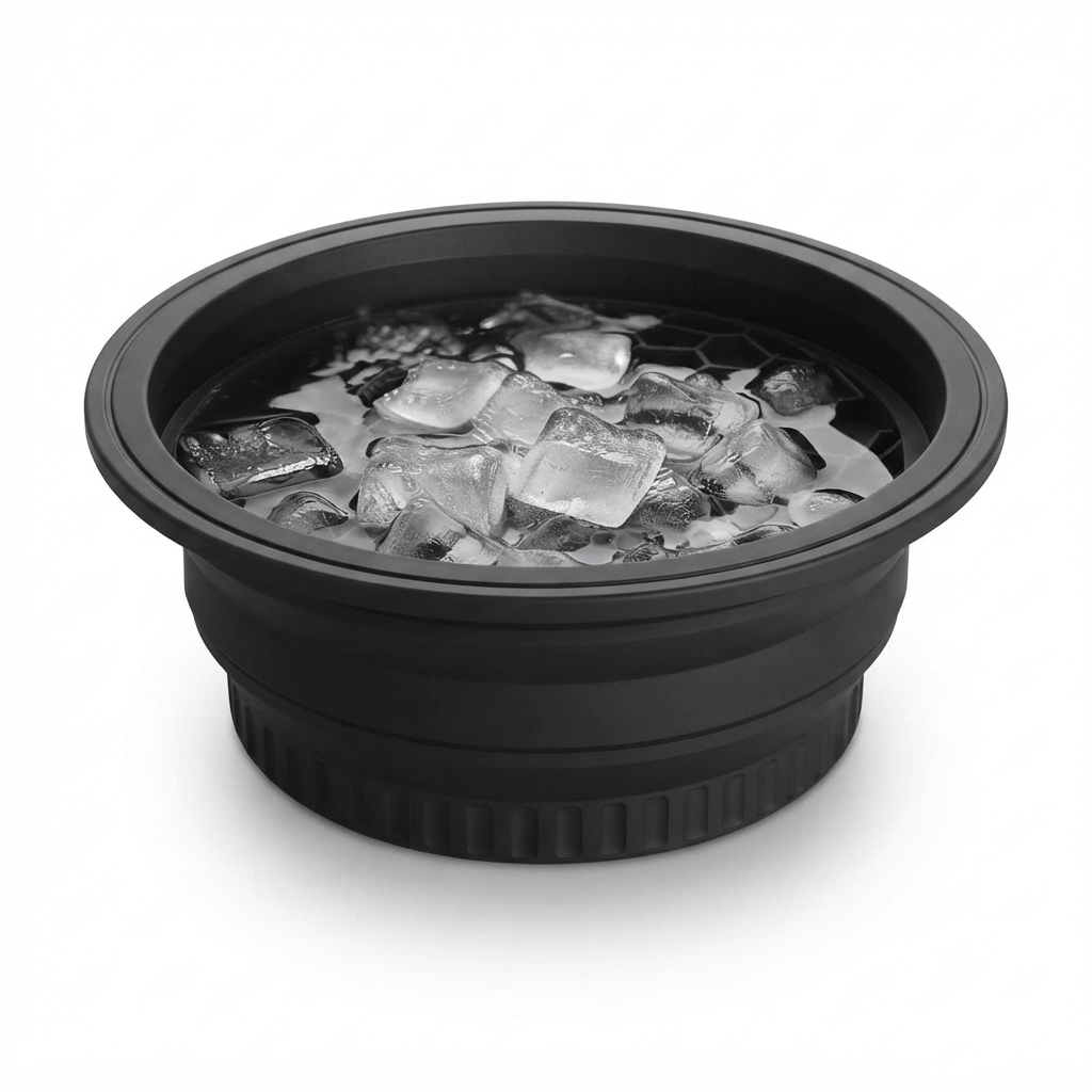 Close-up of the black silicone ice face bowl's rim filled with ice cubes, showing the honeycomb drain pattern inside