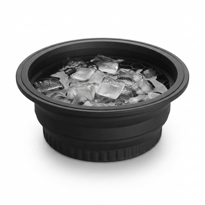 Close-up of the black silicone ice face bowl's rim filled with ice cubes, showing the honeycomb drain pattern inside