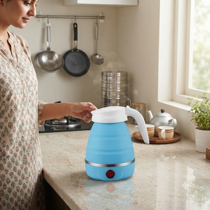 Blue electric foldable kettle on a home kitchen counter with a woman reaching for its handle